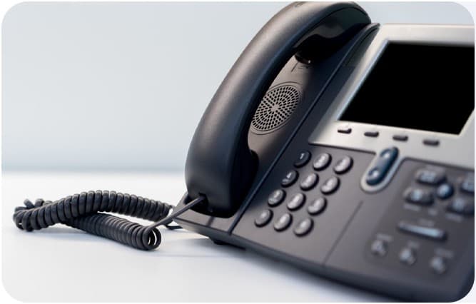 Business VoIP desk phone with handset and coiled cord