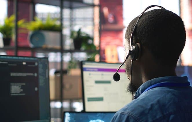 A support advisor wearing a headset at a desk