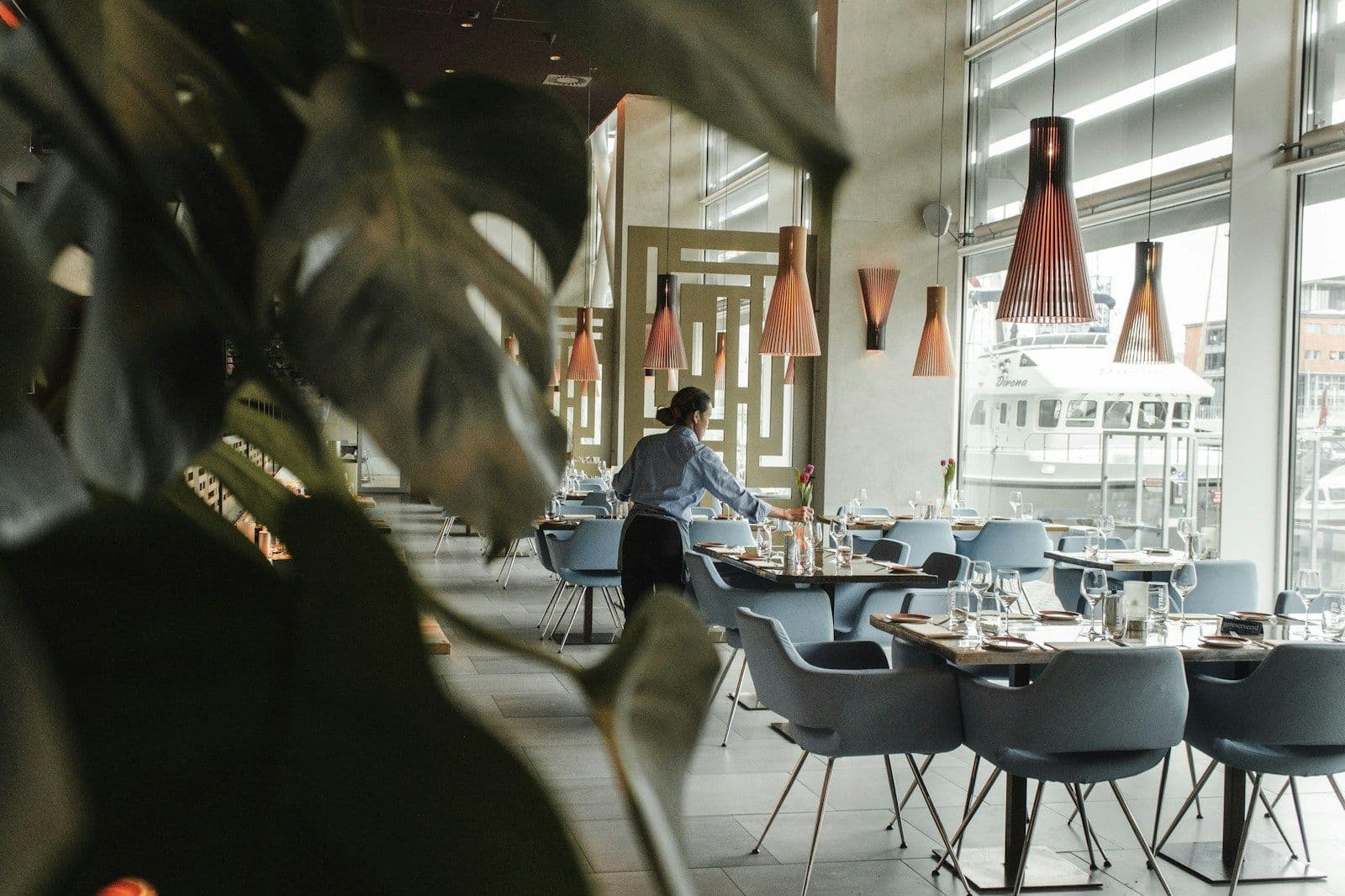A restaurant dining room with tables laid for service