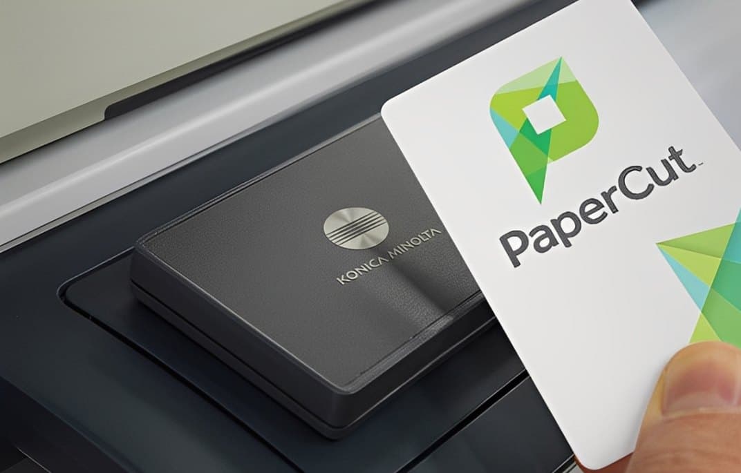 PaperCut card being tapped on a Konica Minolta card reader for secure print release